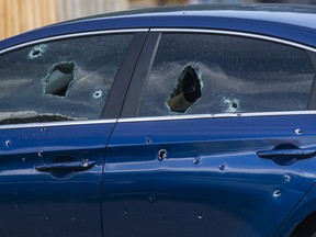 Toronto Police officers investigate after two men were wounded by gunfire and a Hyundai Sonata was riddled with bullet holes at a lowrise apartment complex on Rochefort Dr. in Flemingdon Park in Toronto, Ont. on Wednesday August 7, 2019. Ernest Doroszuk/Toronto Sun/Postmedia