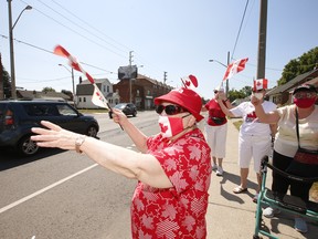 Rita Conn (L) leads a small group of women from Hendriks Court seniors apartments in marking Canada Day in East York on July 1, 2020.