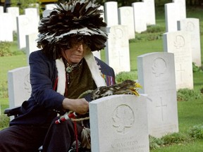 Canadian aboriginal WWII veteran George Harsy pays his respects on Oct. 30, 2005, at graves of the Canadian War Cemetery before a Ceremony of Remembrance in Beny-Reviers, western France. The ceremony took place on the Aboriginal Spiritual Journey to Europe, which honoured First Nations, Metis and the Inuit of Canada who gave their lives in wartime.