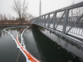 Three booms across the waterway following a reported fuel/oil spill at the bridge along Unwin Ave. in Toronto, Ont. on Tuesday, December 17, 2019. Ottawa's ecological program remains little known, though it was launched four years ago with a promised $1.5 billion in funding.