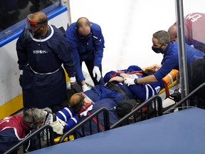 Leafs defenceman Jake Muzzin is carried off the ice on a stretcher during Tuesday's game.