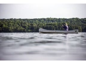A canoeist enjoys some solitude on Meech Lake in Gatineau Park.