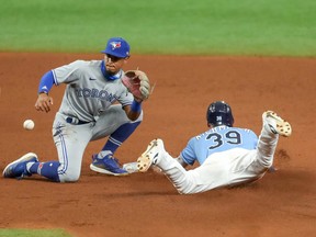 Kevin Kiermaier of the Tampa Bay Rays slides in with a steal of second base as Santiago Espinal of the Toronto Blue Jays awaits a throw in the seventh inning of a baseball game at Tropicana Field on Aug. 23, 2020 in St. Petersburg, Fla.