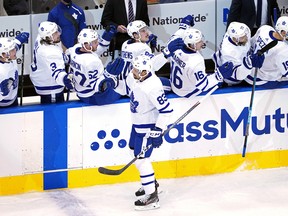 Cody Ceci of the Toronto Maple Leafs is congratulated by his teammates after scoring a goal against the Columbus Blue Jackets during the first period in Game 3 last night.