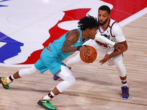 Memphis Grizzlies' Ja Morant, left, drives against Norman Powell of the Toronto Raptors during the third quarter at Visa Athletic Center at ESPN Wide World Of Sports Complex on Aug. 9, 2020 in Lake Buena Vista, Fla.