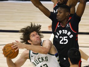 Bucks centre Robin Lopez is pressured by the Raptors’ Chris Boucher during Toronto’s win on Monday night. The Raptors are 5-1 since returning to play.