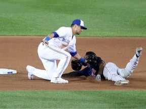 Joe Panik of the Toronto Blue Jays tags out Jackie Bradley Jr. of the Boston Red Sox while attempting to steal second base during the seventh inning at Sahlen Field on August 25, 2020 in Buffalo, New York.