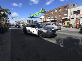 A Toronto Police cruiser travels along Eglinton Ave. W., at Oakwood Ave., on Aug. 30, 2020. This intersection was the scene of a melee which sent four Toronto Police officers to hospital on Saturday night.