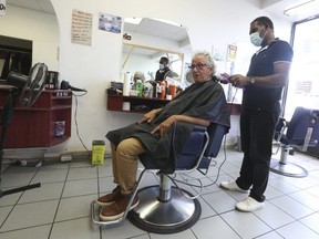 Toronto Councillor Michael Colle gets his hair cut on Aug. 30, 2020, at B&M barber shop on Eglinton Ave. W., at Oakwood Ave.
