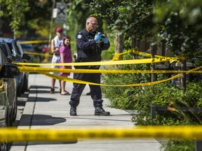 A Toronto Police officer is pictured in the Queen St. W.-Augusta Ave. area after a woman was shot and wounded on Aug. 5, 2020.