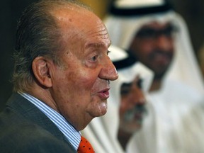 A file photo taken on April 14, 2014 shows Spain's King Juan Carlos greeting United Arab Emirates officials as he arrived at an economic forum in Abu Dhabi.