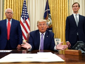 Flanked by U.S. Ambassador to Israel David Melech Friedman and White House senior adviser Jared Kushner, U.S. President Donald Trump speaks about a peace deal reached between Israel and the United Arab Emirates during from the Oval Office of the White House in Washington, U.S., Aug. 13, 2020.