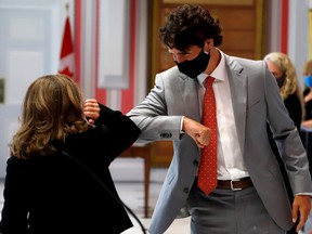 Chrystia Freeland, deputy prime minister, elbow bumps Prime Minister Justin Trudeau after she is sworn in as finance minister at Rideau Hall in Ottawa, Aug. 18, 2020.