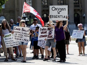 On the first day of Edmonton's mandatory indoor public space mask bylaw, approximately 50 anti-mask protesters marched from the Alberta Legislature to Edmonton City Hall, Aug. 1, 2020.