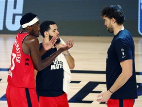 From left, Raptors' Pascal Siakam, Fred VanVleet and Marc Gasol talk during a game last week.