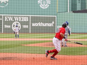 Mitch Moreland, along with Blue Jays Bo Bichette and Thomas Hatch, watch as the Red Sox slugger clears the Green Monster for a walkoff two-run homer in the ninth yesteday at Fenway Park.