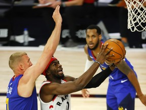 Terence Davis of the Toronto Raptors drives the ball against Mason Plumlee of the Denver Nuggets during the third quarter at The Field House at ESPN Wide World Of Sports Complex.