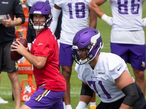 Minnesota Vikings quarterback Kirk Cousins (8) drops back to pass at training camp at TCO Performance Center.