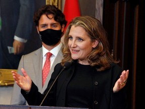 Deputy Prime Minister and Finance Minister Chrystia Freeland speaks to reporters next to Prime Minister Justin Trudeau on Parliament Hill in Ottawa Aug. 18, 2020.