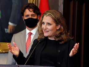 Deputy Prime Minister and Finance Minister Chrystia Freeland speaks to reporters next to Prime Minister Justin Trudeau on Parliament Hill in Ottawa August 18, 2020.