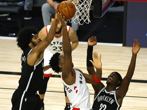 Jarrett Allen of the Brooklyn Nets blocks a shot by OG Anunoby of the Toronto Raptors.