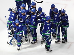 The Vancouver Canucks celebrate their 6-2 win over the St. Louis Blues to win their series in six games.