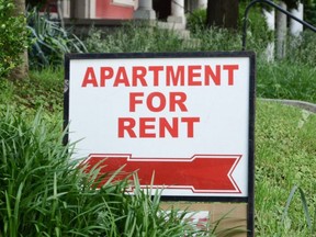 Apartment for rent sign displayed on a residential street.