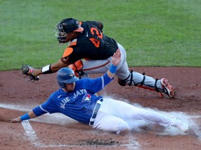 Toronto Blue Jays second baseman Cavan Biggio slides safety into home against Baltimore Orioles catcher Pedro Severino Sunday at Sahlen Field.