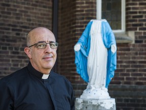 Father Walid El Khoury with a vandalized statue of Mother Mary in front of Our Lady of Lebanon Parish along Queen St. W. in the Parkdale neighbourhood in Toronto, Ont. on Monday August 31, 2020.