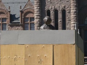 The statue of Sir John A. Macdonald at Queen's Park is wrapped up and boxed in on Aug. 31, 2020.