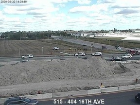 First responders are seen at the scene where an airplane landed beside highway 404 in Markham, Ont., in a still image made from traffic camera footage on Sunday, Aug. 30, 2020.