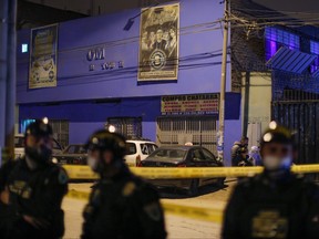 Police officers stand guard on Aug. 23, 2020 outside the nightclub in Lima where at least 13 people suffocated in a crush during a raid late on Aug. 22 where a party was being held despite a ban on such gatherings imposed to fight the COVID-19 novel coronavirus pandemic.