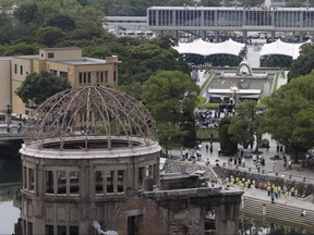 The Atomic Bomb Dome is seen in front of the venue holding a ceremony to mark the 75th anniversary of the atomic bombing, at the Hiroshima Peace Memorial Park in Hiroshima, Japan, Thursday, Aug. 6, 2020.