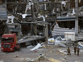 Military personnel stand amid debris from nearby structures, damaged by an explosion a day earlier, on Wednesday, Aug. 5, 2020 in Beirut, Lebanon.