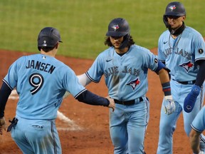 Toronto Blue Jays shortstop Bo Bichette (middle) celebrates with catcher Danny Jansen (9) after hitting a home run against the Miami Marlins at Sahlen Field.