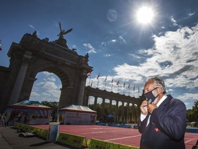 John Kiru, president of the Canadian National Exhibition, puts on a face mask during the opening ceremonies of CNE At Home: The Virtual Fair @ TheEx.com by the Princes' Gates in Toronto, Ont. on Friday, Aug. 21, 2020. Because of COVID-19, this year's CNE has gone entirely online from Aug. 21 to Sept. 7, 2020.