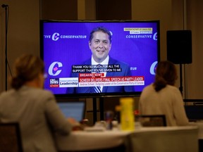 Andrew Scheer, seen on a TV in the media room, makes his last speech as Canada's Conservative Party leader in Ottawa, Ontario, Canada August 23, 2020.
