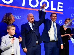 Newly elected Conservative Leader Erin O?Toole has his hand hoisted by outgoing leader Andrew Scheer as he stands his wife and children after delivering his winning speech following the Conservative party of Canada 2020 Leadership Election in Ottawa, Ontario, Canada August 24, 2020.