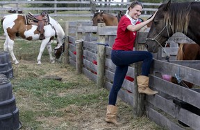 Alexa Knautz enjoys spending time with the horses at Pathways on Pleasure Valley. Veronica Henri/Toronto Sun