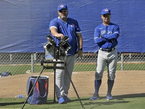 Blue Jays coach Ken Huckaby (left) and manager Charlie Montoyo wait to run catching drills at the team's spring training facilities in Dunedin, Fla., Sunday, Feb. 16, 2020. Steve Nesius/The Canadian Press Files