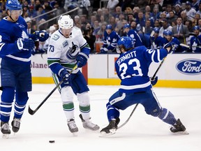 Maple Leafs defencemen Justin Holl (left) and Travis Dermott, here converging on Canucks winger Tyler Toffoli, will be blue-line partners once again in Game 3 tonight against the Columbus Blue Jackets.