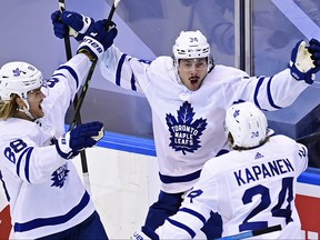 Toronto Maple Leafs' Auston Matthews (34) celebrates his game winning goal against the Columbus Blue Jackets' with teammates William Nylander (88) and Kasperi Kapanen (24) during overtime NHL Eastern Conference Stanley Cup playoff action in Toronto on Friday, August 7, 2020.