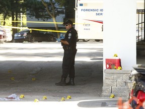 Toronto Police at the scene of a fatal shooting in an alcove of a building at 1350 Danforth Rd.  on Wednesday August 12, 2020.