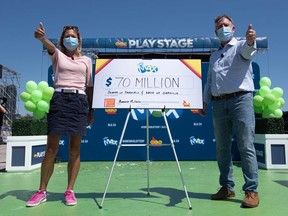Donna Williamson of Thornhill and David Overall of Oakville celebrate their $70 Million Lotto Max win at the OLG Play Stage at Ontario Place in downtown Toronto on Friday, Aug. 14 2020