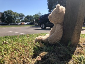 A teddy bear left near the scene outside an apartment parking lot on Confederation Pkwy. in Mississauga where a toddler was killed by a delivery van, Wednesday, Aug. 12, 2020.