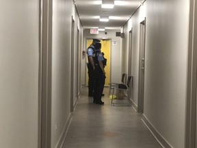 Special constables guard the door of an apartment where two people were found dead in a Scarborough apartment in Sunday, Aug. 23, 2020