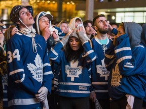 Leafs' fans face the reality the Toronto Maple Leafs will lose to the Boston Bruins towards the end of  Game 7, during the First Round playoffs, as they watch on the big screens outside of Scotiabank Arena on Bremner Blvd in Toronto, Ont. on Tuesday April 23, 2019. Ernest Doroszuk/Toronto Sun/Postmedia