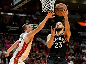 Raptors guard Fred VanVleet (right) shoots around Heat forward Duncan Robinson (left) during the first half NBA action at American Airlines Arena in Miami, Jan. 2, 2020.