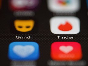 The "Grindr" and "Tinder" app logos are seen on a mobile phone screen in this Nov. 24, 2016 file photo.