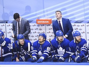 Toronto Maple Leafs head coach Sheldon Keefe, back right, looks at the score board in the final seconds of third period NHL Eastern Conference Stanley Cup playoff action against the Columbus Blue Jackets, in Toronto, Sunday, Aug. 2, 2020.